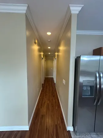 a view of a hallway with wooden floor