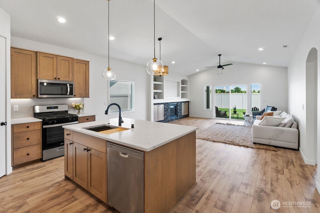231 Shrute Road Prosser, WA 99350 - Photo 2 of 36 a open kitchen with stainless steel appliances granite countertop a sink a stove and a wooden floors