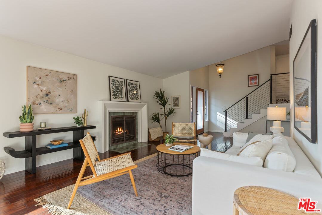 a living room with furniture a fireplace and a table