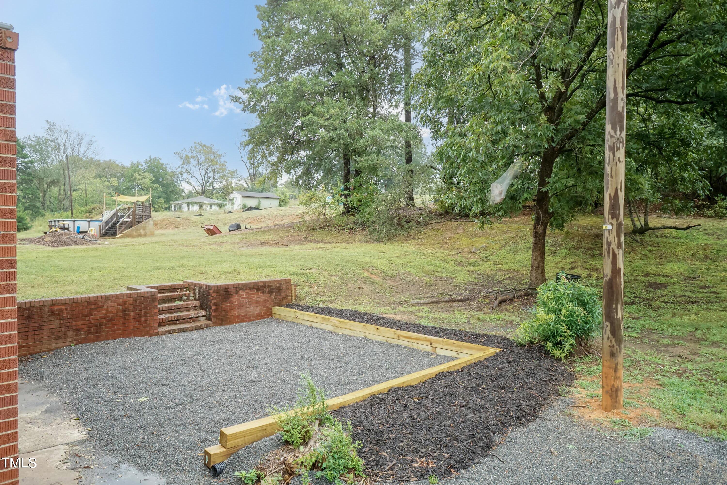 139 Johnson Street Roxboro, NC 27573 - Photo 28 of 30 a view of a field with an trees