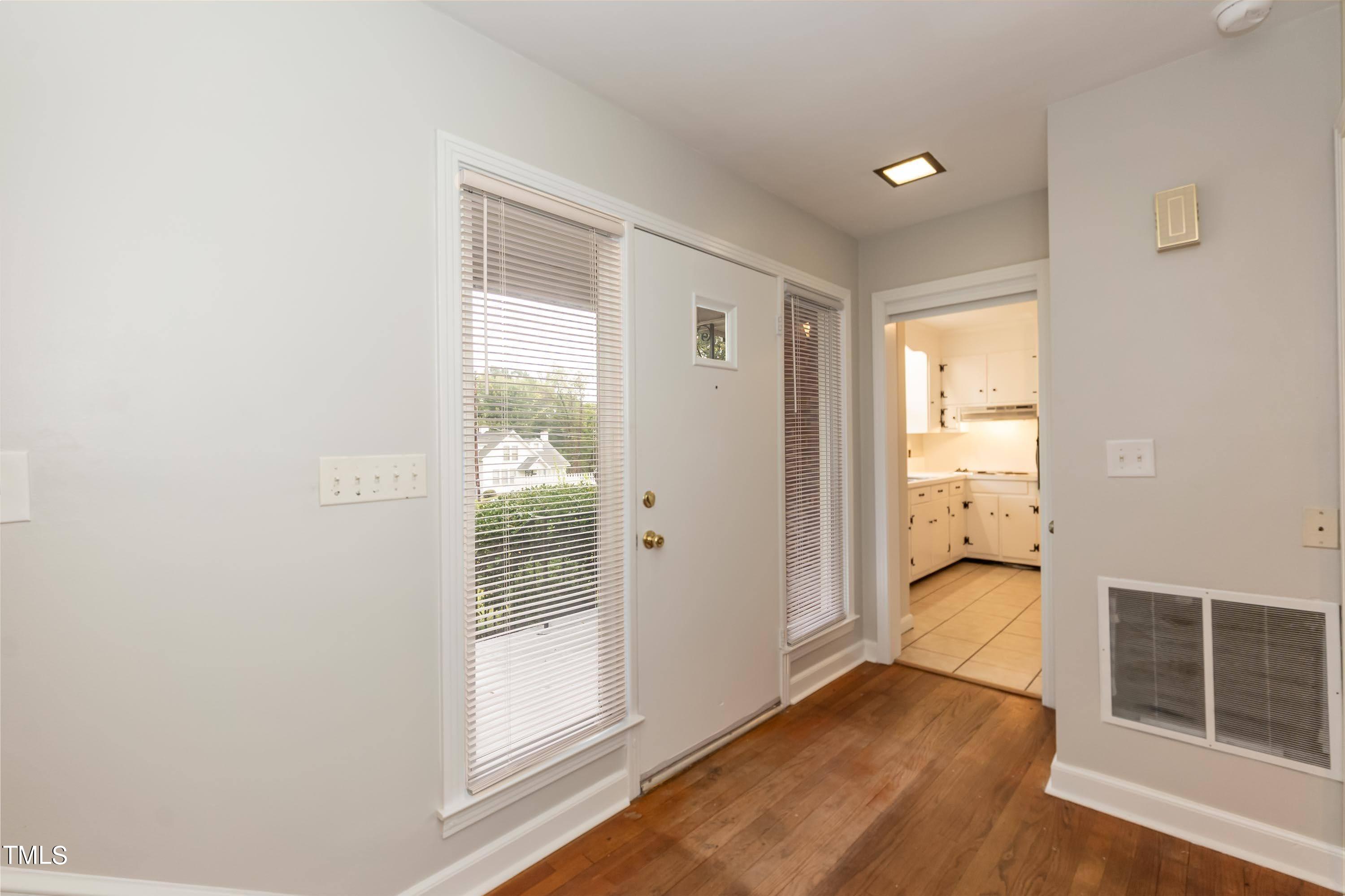 139 Johnson Street Roxboro, NC 27573 - Photo 4 of 30 a view of a hallway with wooden floor and cabinet