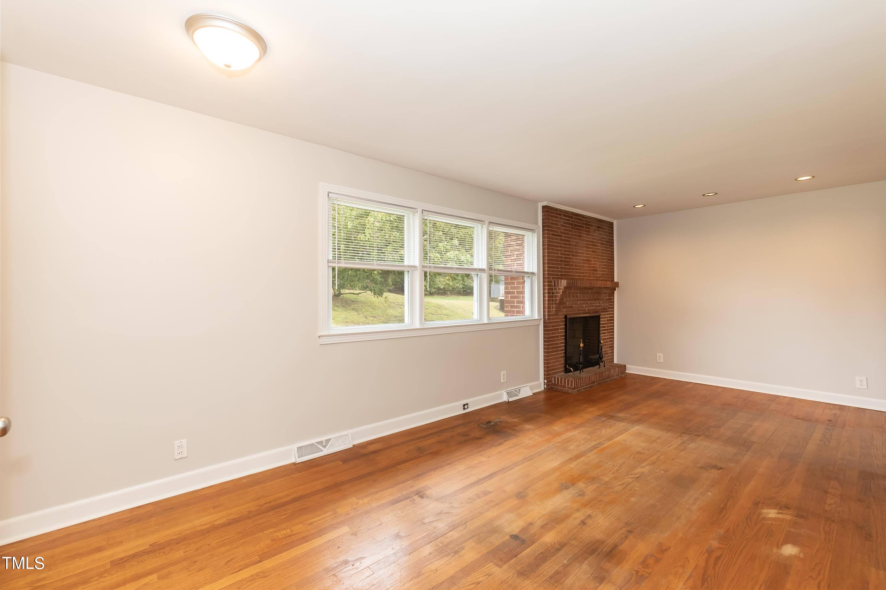 139 Johnson Street Roxboro, NC 27573 - Photo 6 of 30 an empty room with windows and closet