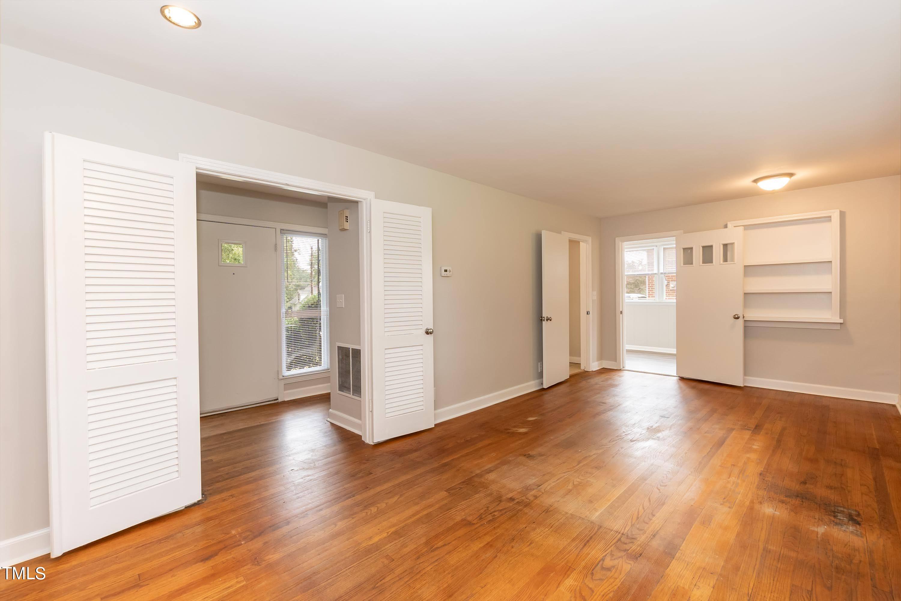 139 Johnson Street Roxboro, NC 27573 - Photo 7 of 30 an empty room with wooden floor closet and windows