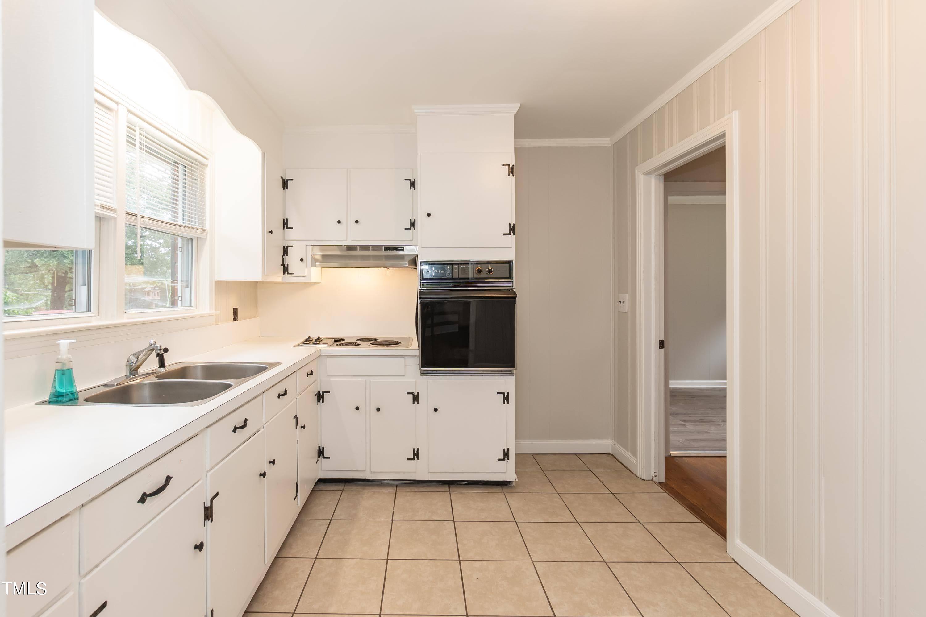 139 Johnson Street Roxboro, NC 27573 - Photo 9 of 30 a kitchen with granite countertop white cabinets and appliances