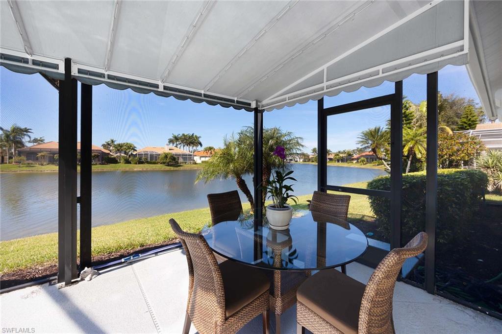 8943 Lely Island Circle Naples, FL 34113 - Photo 29 of 40 a view of a dining room with furniture and window