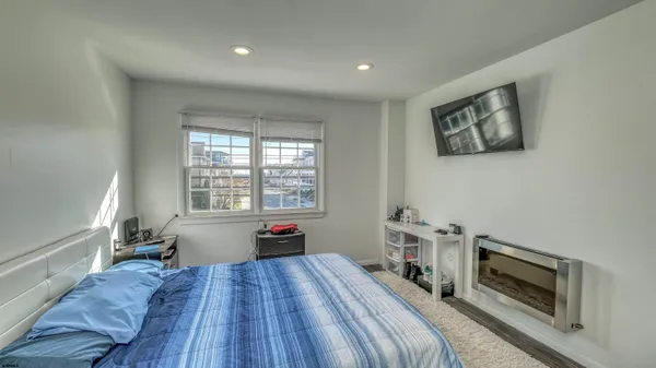 a bed room with a bed and a tv