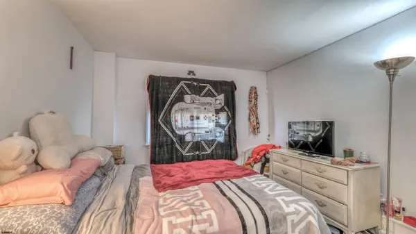 a bedroom with a bed and a couch