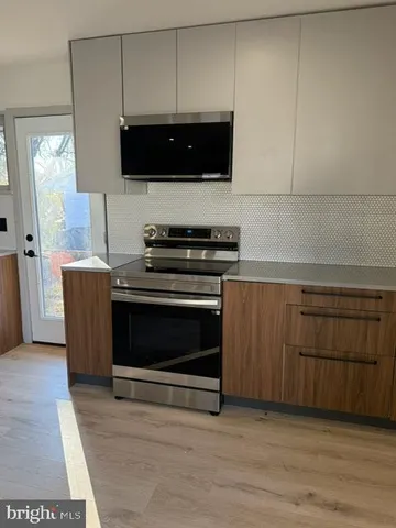 a kitchen with a stove and a microwave