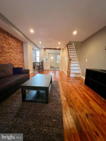 a living room with stainless steel appliances furniture