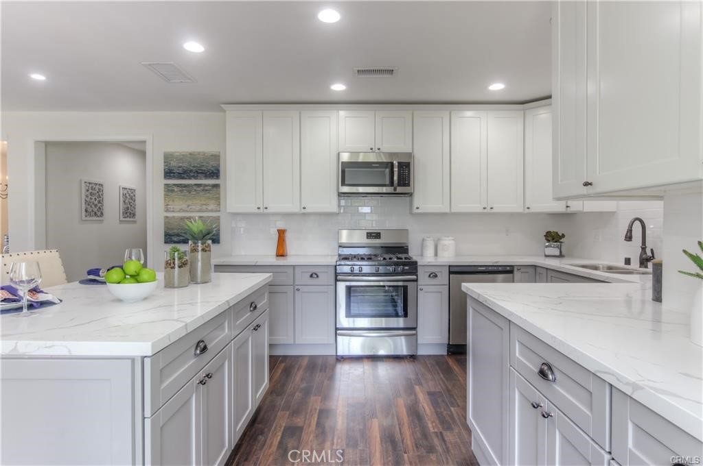 1925 North Screenland Drive Burbank, CA 91505 - Photo 12 of 31 a kitchen with kitchen island granite countertop a sink a stove top oven a counter space and cabinets