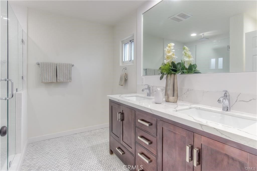 1925 North Screenland Drive Burbank, CA 91505 - Photo 18 of 31 a bathroom with a granite countertop sink a mirror and a shower