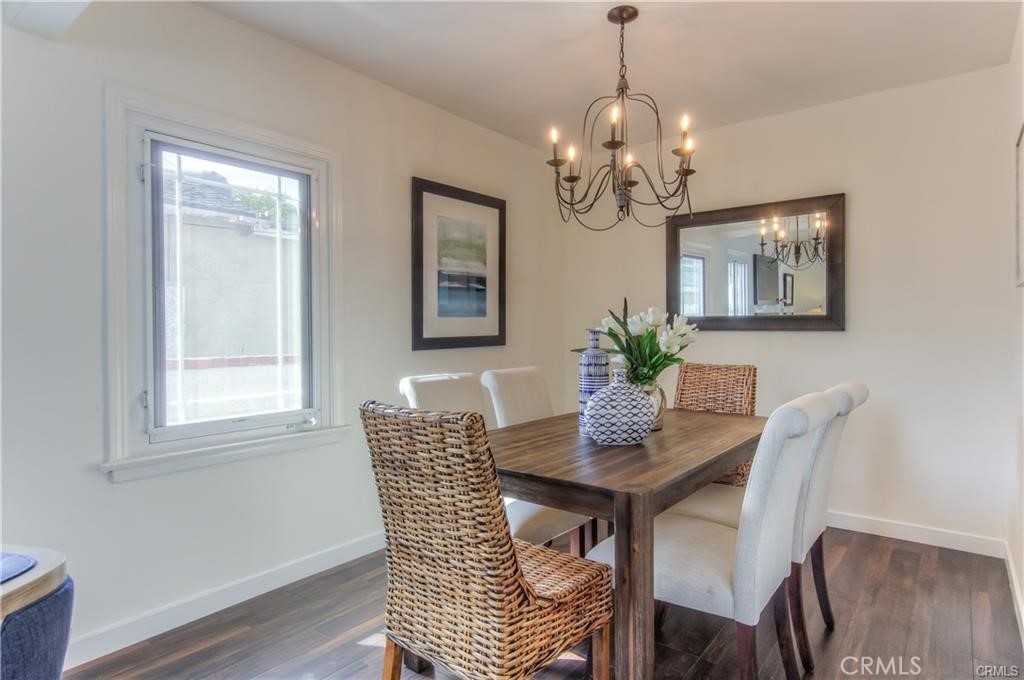 1925 North Screenland Drive Burbank, CA 91505 - Photo 4 of 31 a dining room with wooden floor a chandelier a wooden table and chairs