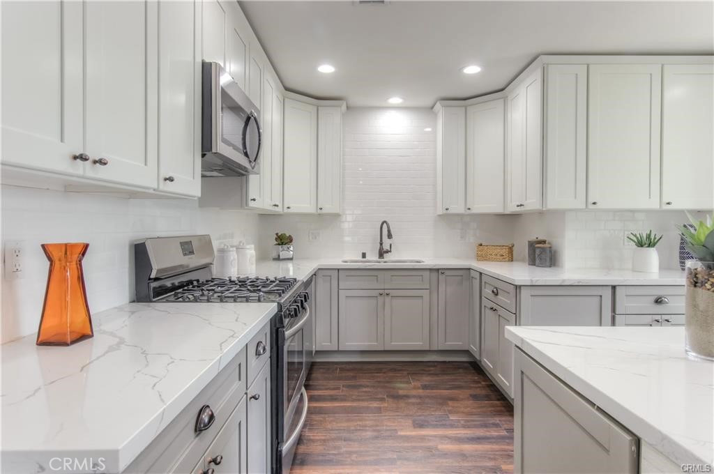 1925 North Screenland Drive Burbank, CA 91505 - Photo 10 of 31 a kitchen with a white stove top oven sink and cabinets