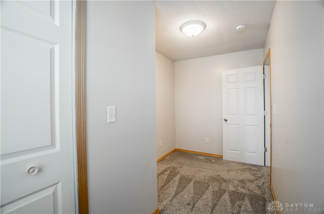 1442 Langdon Road Sidney, OH 45365 - Photo 24 of 34 This cozy bedroom features plush carpeting and ample natural light, creating a welcoming retreat.