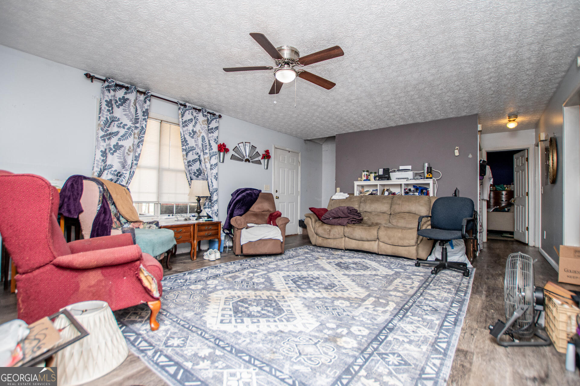 1227 Horsley Mill Road Carrollton, GA 30116 - Photo 14 of 70 a living room with furniture chess board and a rug