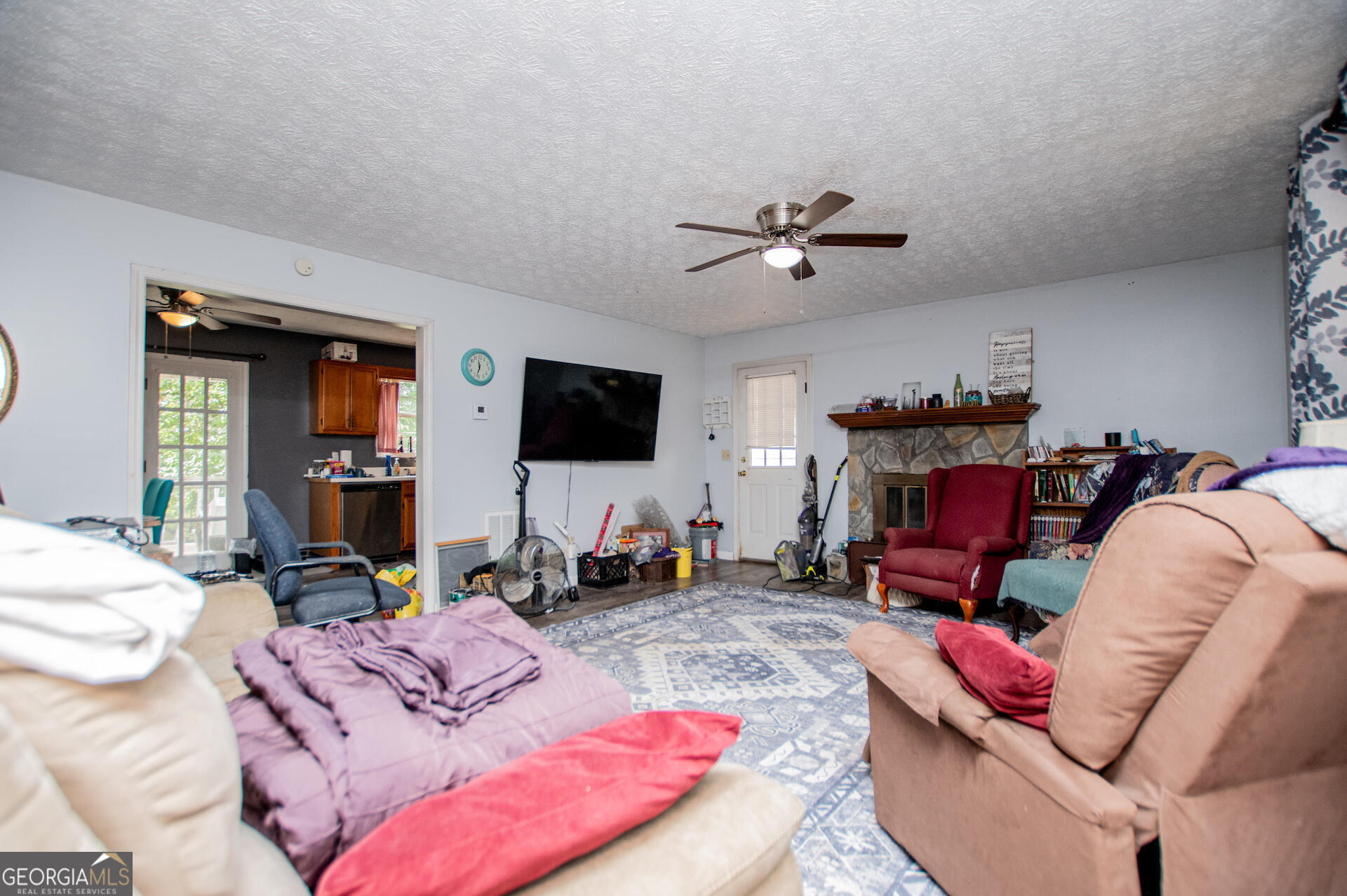 1227 Horsley Mill Road Carrollton, GA 30116 - Photo 16 of 70 a living room with furniture a flat screen tv and a fireplace