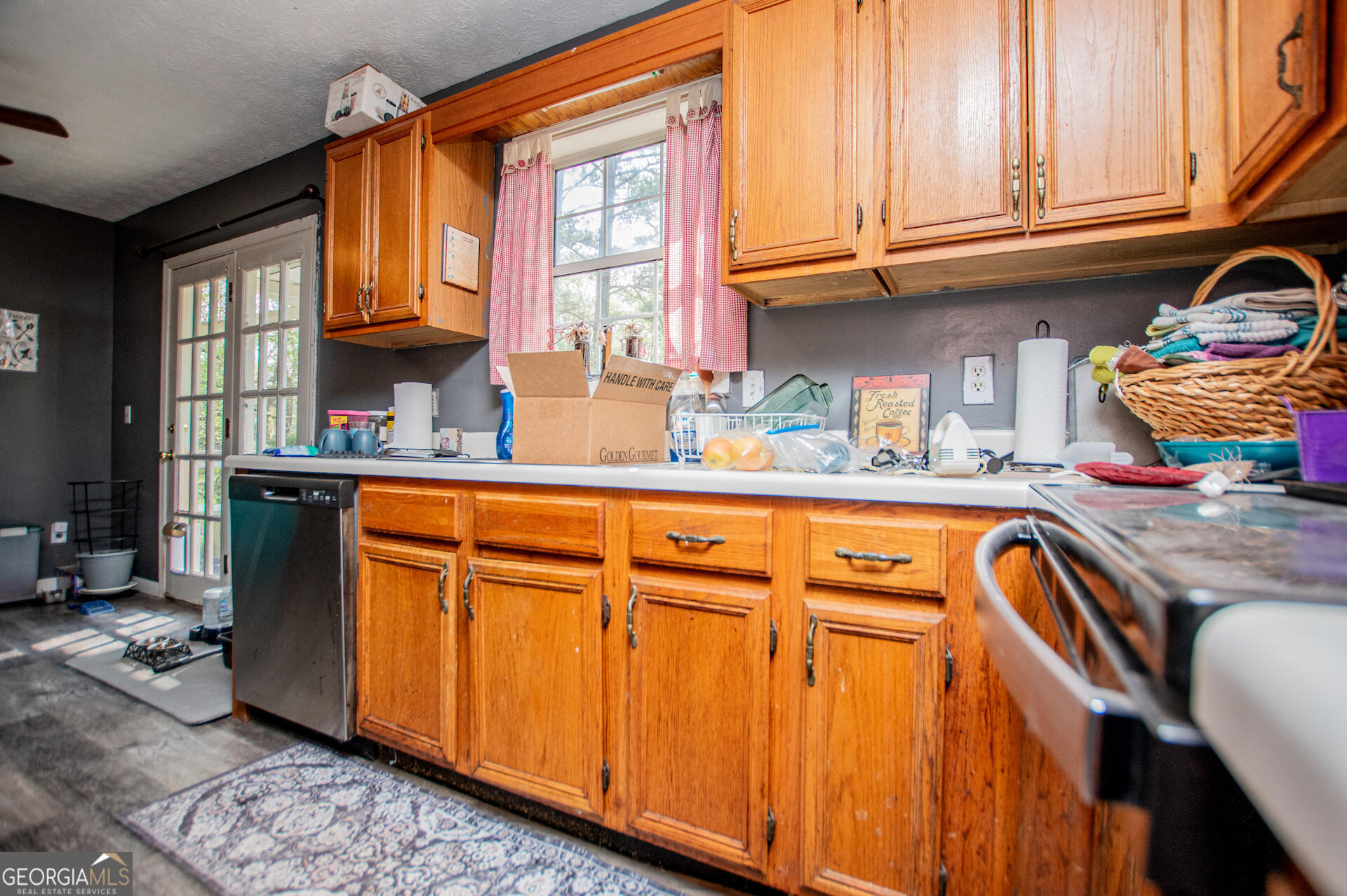 1227 Horsley Mill Road Carrollton, GA 30116 - Photo 19 of 70 a kitchen with stainless steel appliances granite countertop a sink and cabinets