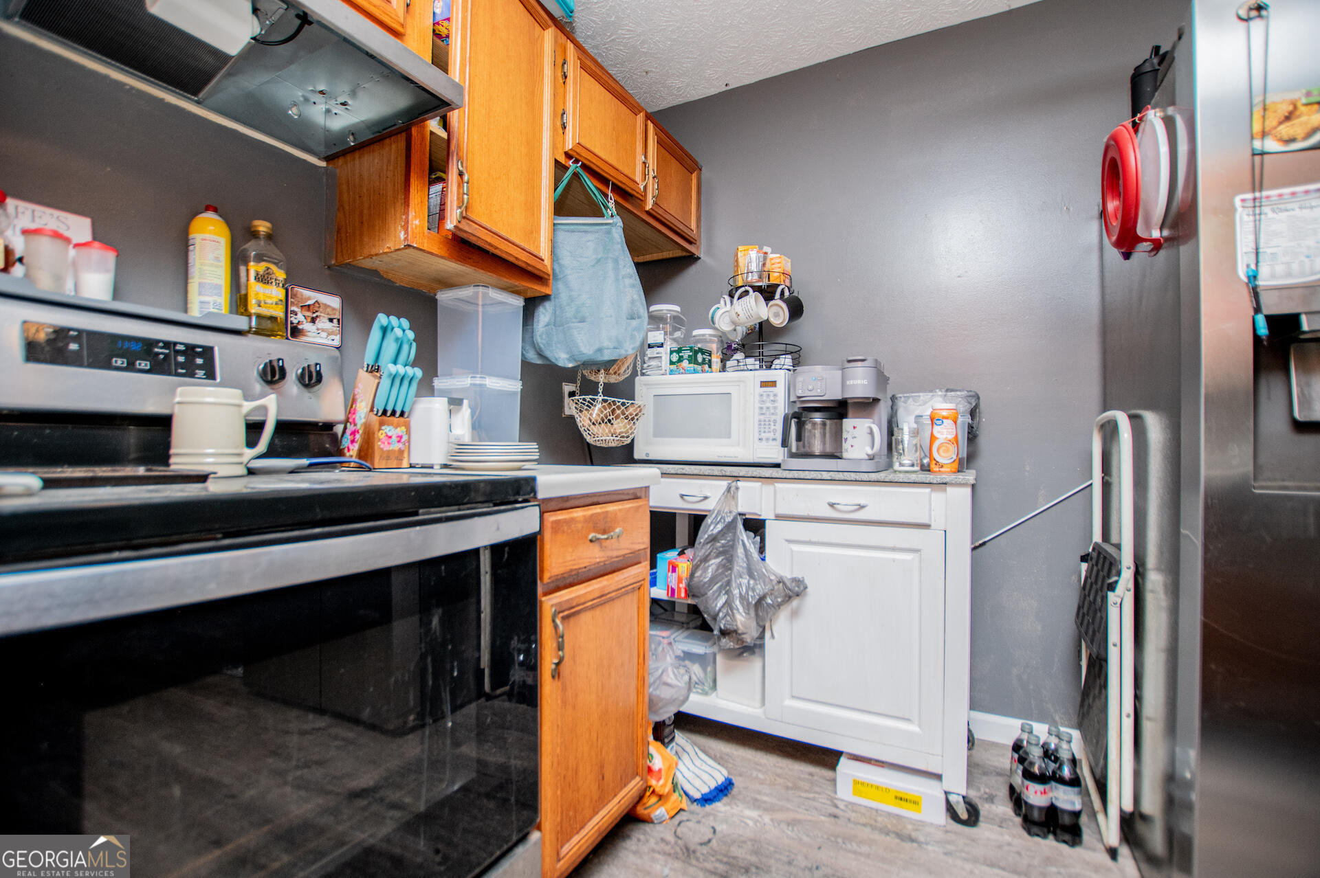1227 Horsley Mill Road Carrollton, GA 30116 - Photo 21 of 70 a kitchen with stainless steel appliances granite countertop a refrigerator and a stove top oven