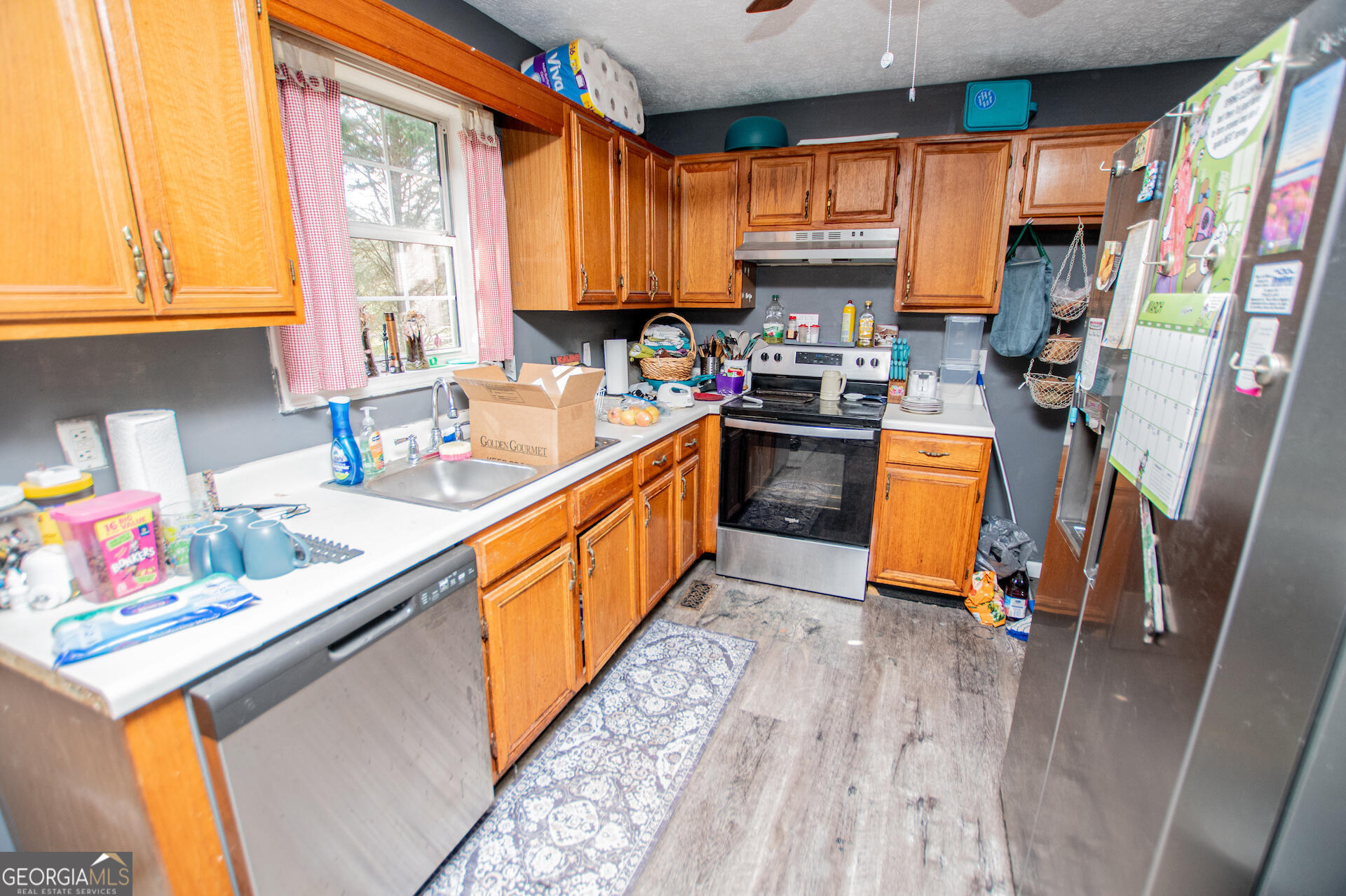 1227 Horsley Mill Road Carrollton, GA 30116 - Photo 23 of 70 a kitchen with stainless steel appliances a sink window and cabinets