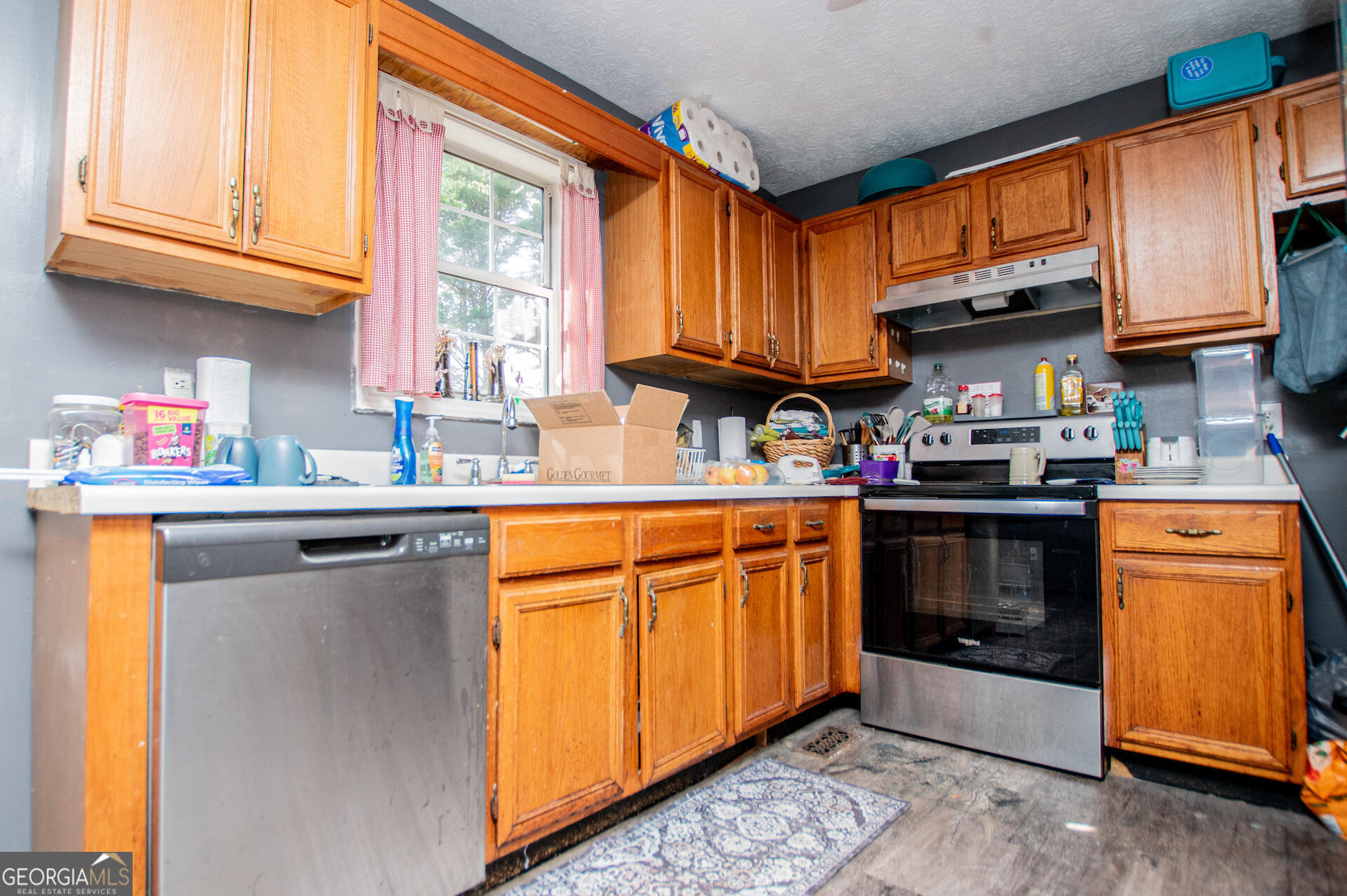 1227 Horsley Mill Road Carrollton, GA 30116 - Photo 24 of 70 a kitchen with stainless steel appliances granite countertop a sink a stove and a refrigerator