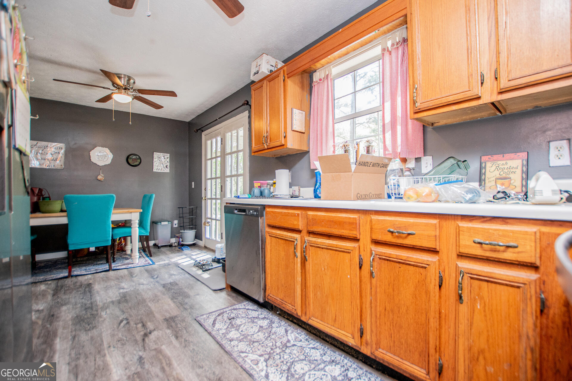 1227 Horsley Mill Road Carrollton, GA 30116 - Photo 26 of 70 a kitchen with stainless steel appliances granite countertop a refrigerator a sink dishwasher and wooden cabinets