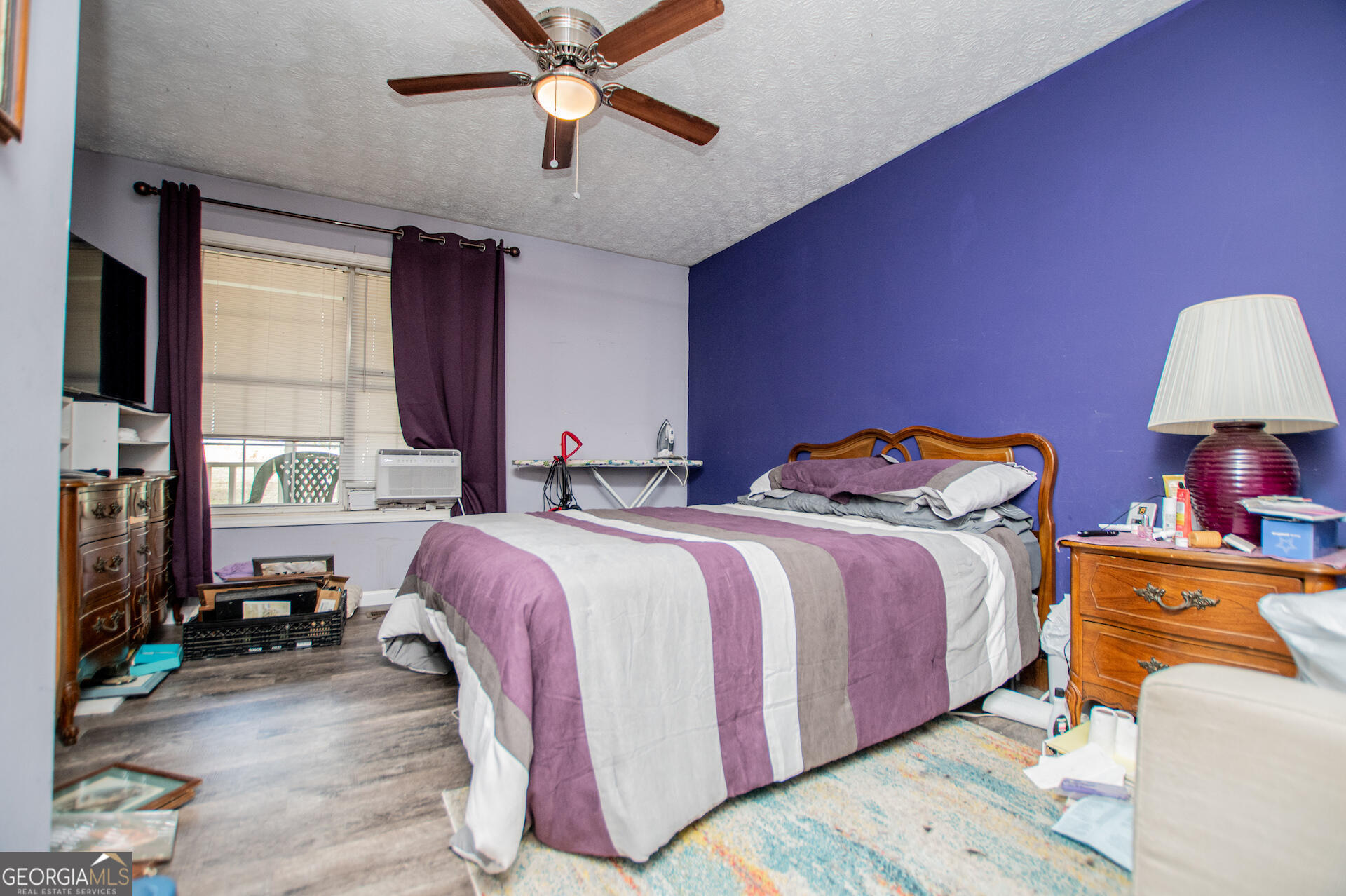 1227 Horsley Mill Road Carrollton, GA 30116 - Photo 28 of 70 a spacious bedroom with a bed and a chandelier