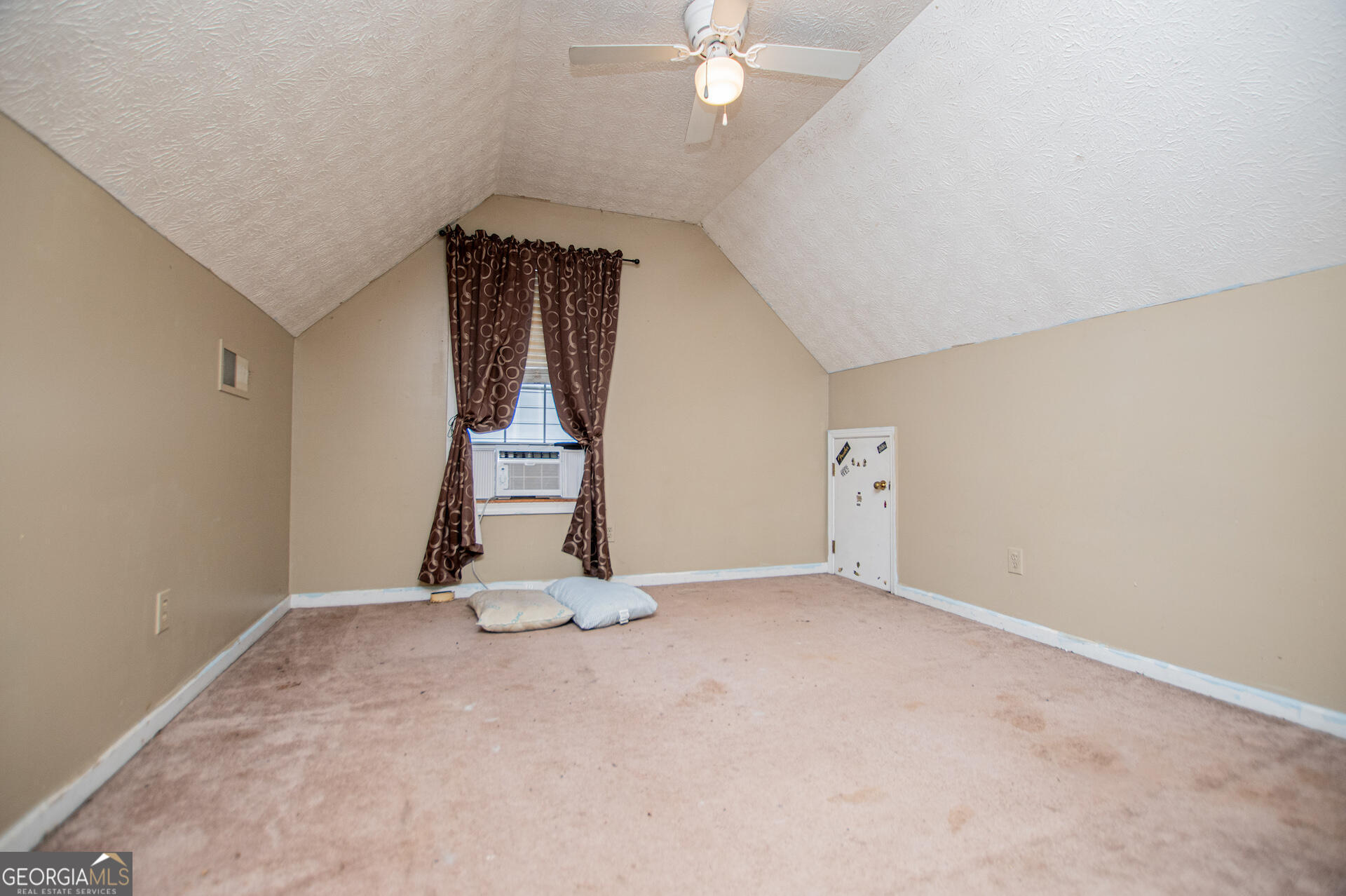 1227 Horsley Mill Road Carrollton, GA 30116 - Photo 39 of 70 an empty room with a chandelier fan and windows