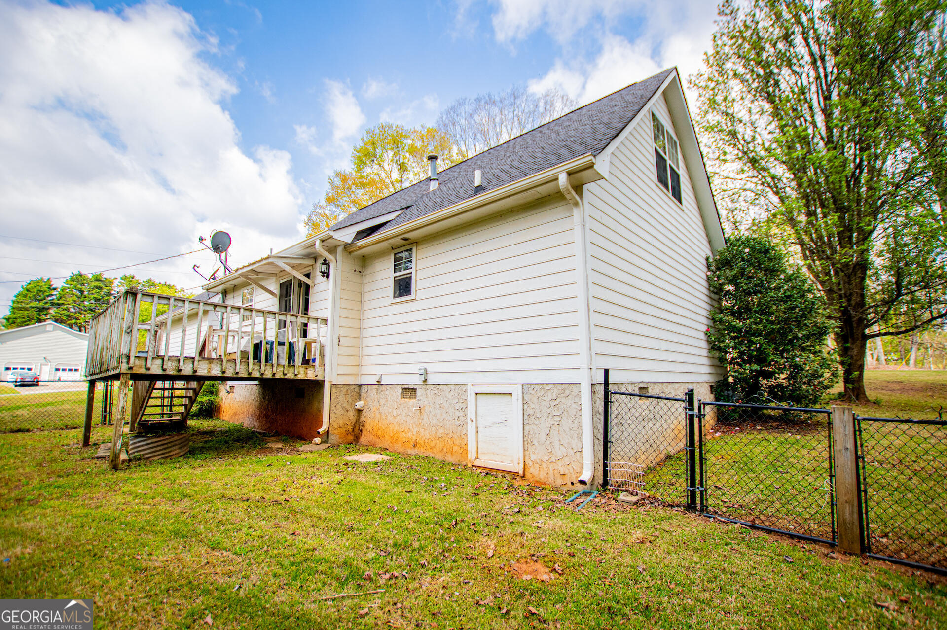1227 Horsley Mill Road Carrollton, GA 30116 - Photo 53 of 70 a view of a white house with a yard and sitting area