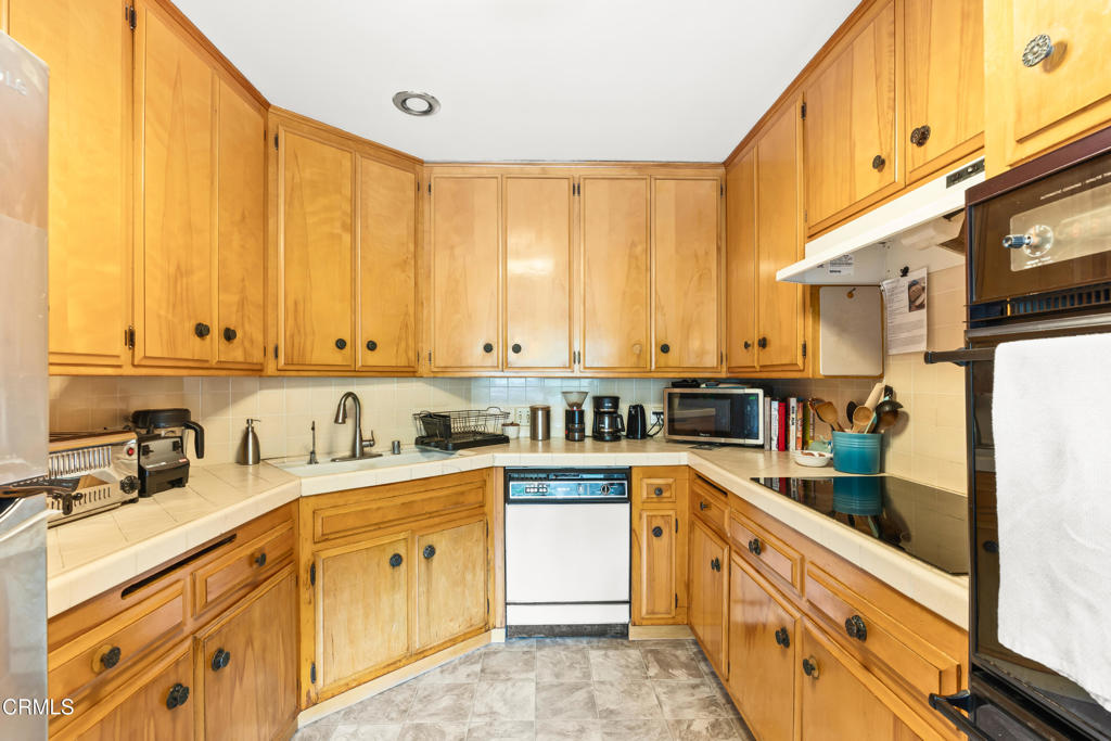 10840 Santa Rosa Road Camarillo, CA 93012 - Photo 31 of 55 a kitchen with stainless steel appliances granite countertop a sink a stove and cabinets