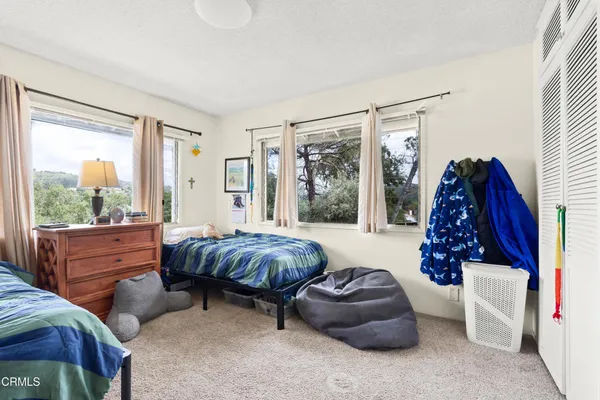 a room with furniture a bookshelf and a window