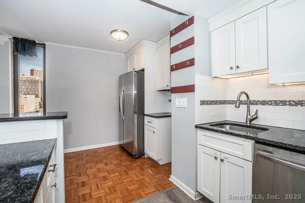 a kitchen with stainless steel appliances granite countertop a refrigerator sink and cabinets