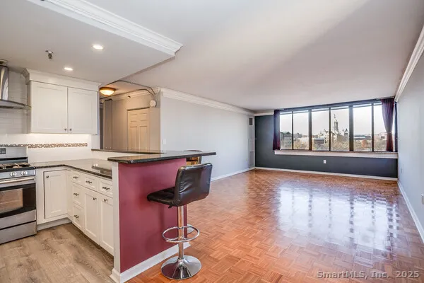 a kitchen with cabinets and wooden floor