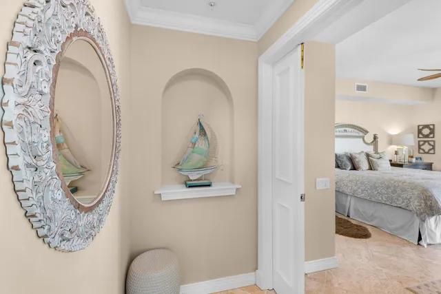 a bedroom with a bed and a mirror