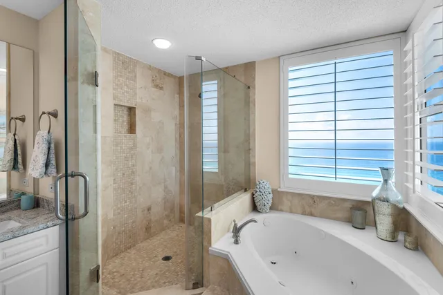 a bathroom with a granite countertop sink mirror toilet and bathtub