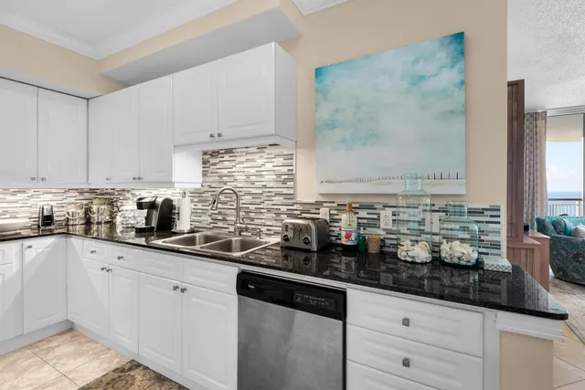 a kitchen with sink and cabinets