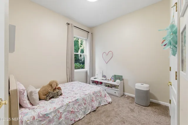 a bedroom with a bed and a potted plant
