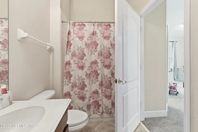 a white toilet sitting next to a bathroom sink