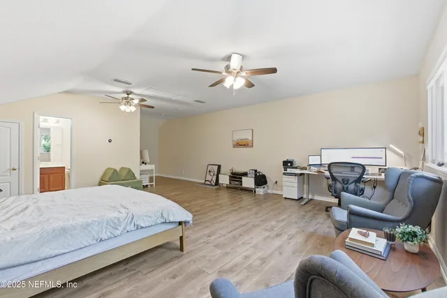 a bedroom with bed couch and window