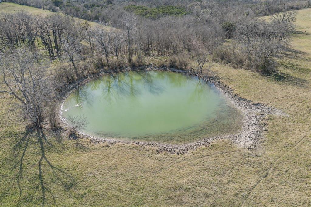 1325 North Katy Road Elm Mott, TX 76640 - Photo 20 of 29 Functional stock pond located on the property, supporting livestock, wildlife, and everyday ranch operations.
