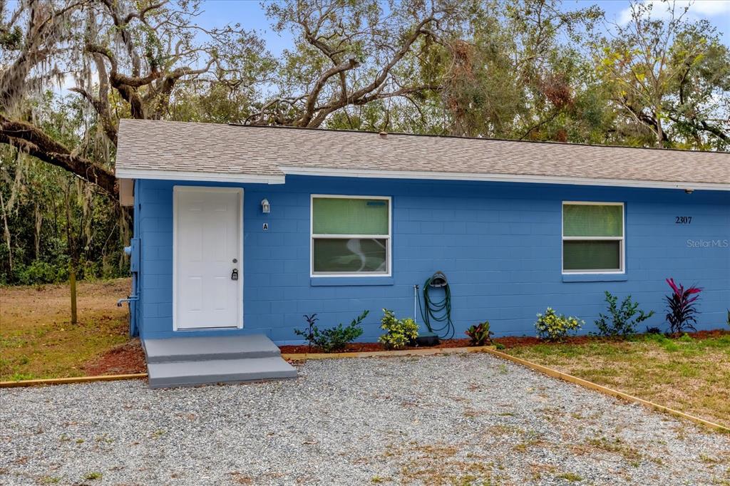 2307 Mispah Avenue, Unit A Leesburg, FL 34748 - Photo 1 of 25 a front view of a house with a yard