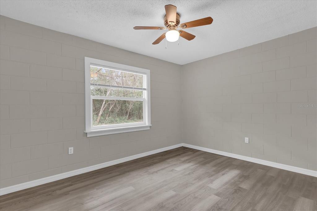 2307 Mispah Avenue, Unit A Leesburg, FL 34748 - Photo 12 of 25 an empty room with a window and a fan