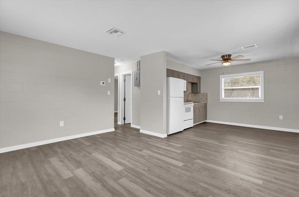 2307 Mispah Avenue, Unit A Leesburg, FL 34748 - Photo 15 of 25 a view of an empty room with a window and wooden floor