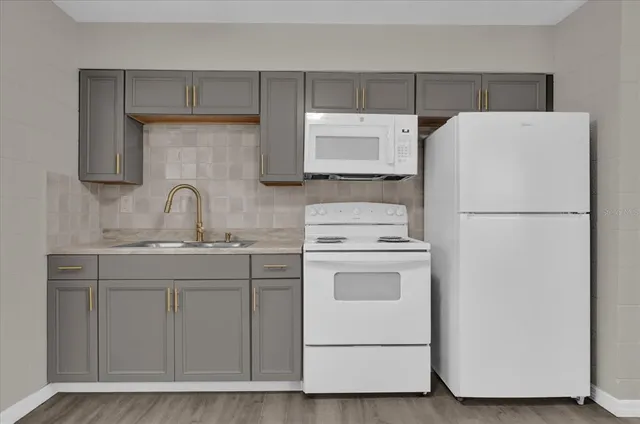 a utility room with sink dryer and washer