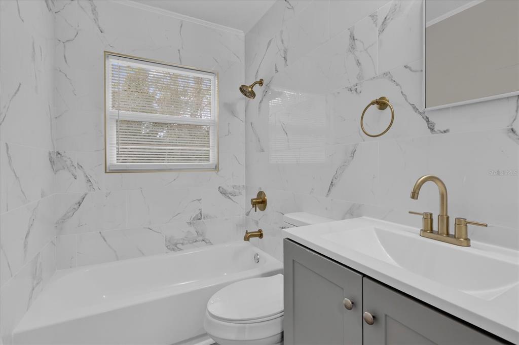 2307 Mispah Avenue, Unit A Leesburg, FL 34748 - Photo 17 of 25 a bathroom with a sink a toilet and a bathtub