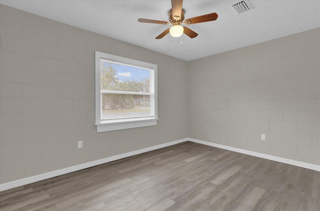 2307 Mispah Avenue, Unit A Leesburg, FL 34748 - Photo 18 of 25 wooden floor in an empty room with a window