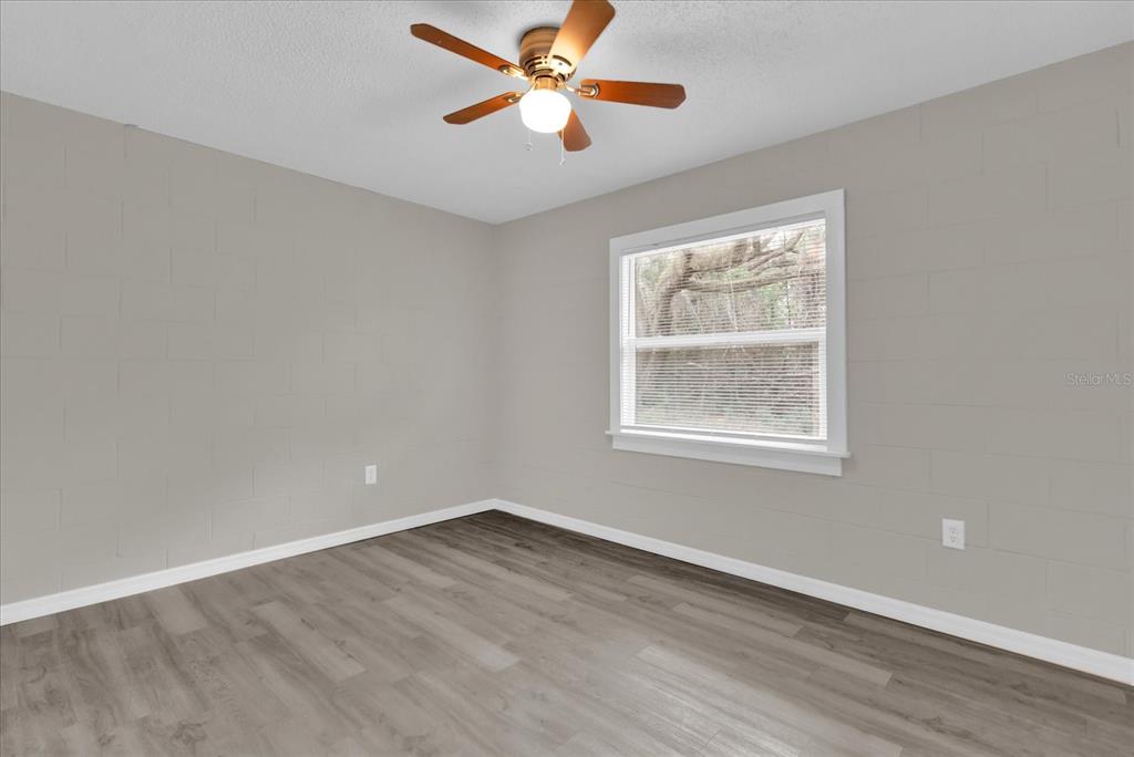 2307 Mispah Avenue, Unit A Leesburg, FL 34748 - Photo 20 of 25 a view of empty room with wooden floor and fan