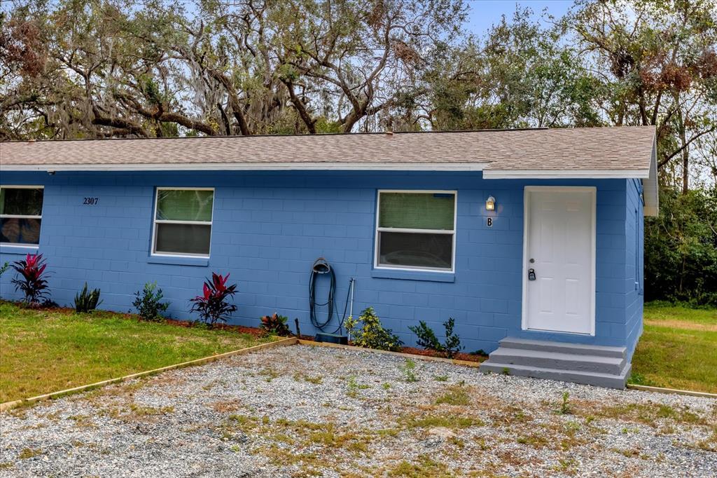 2307 Mispah Avenue, Unit A Leesburg, FL 34748 - Photo 3 of 25 a front view of a house with a yard