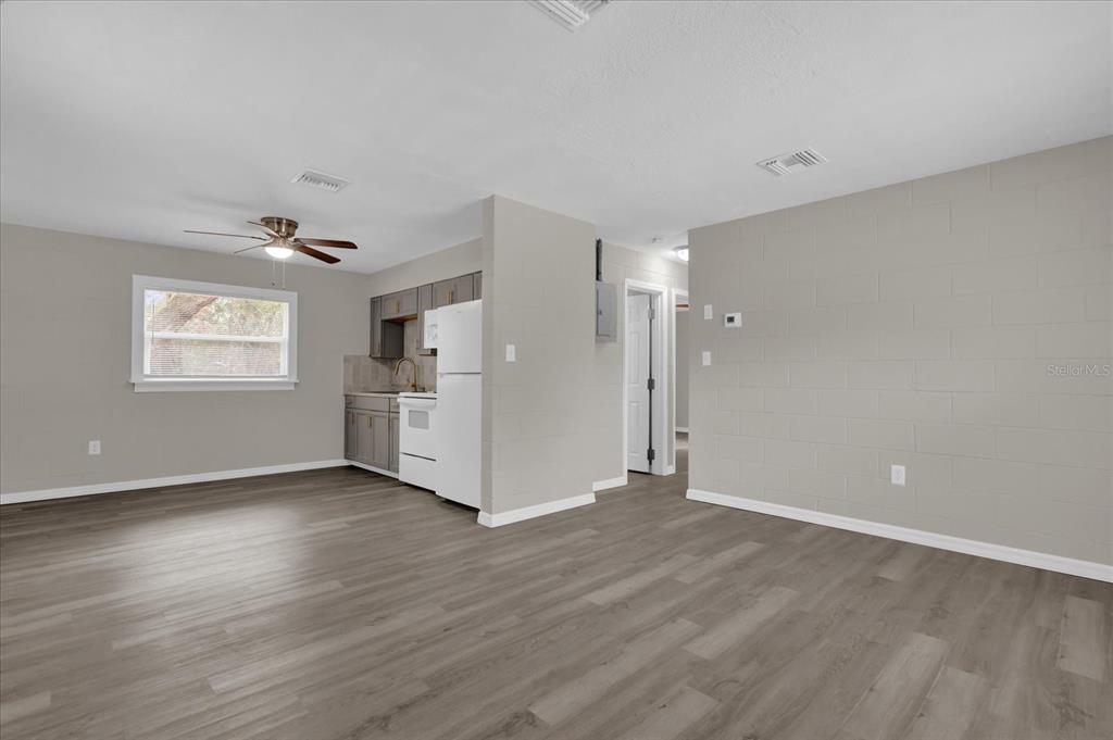 2307 Mispah Avenue, Unit A Leesburg, FL 34748 - Photo 5 of 25 a view of an empty room with wooden floor and a window