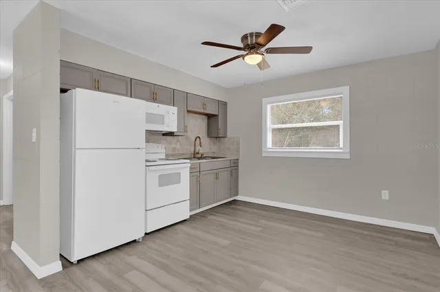 a white refrigerator freezer sitting inside of a kitchen