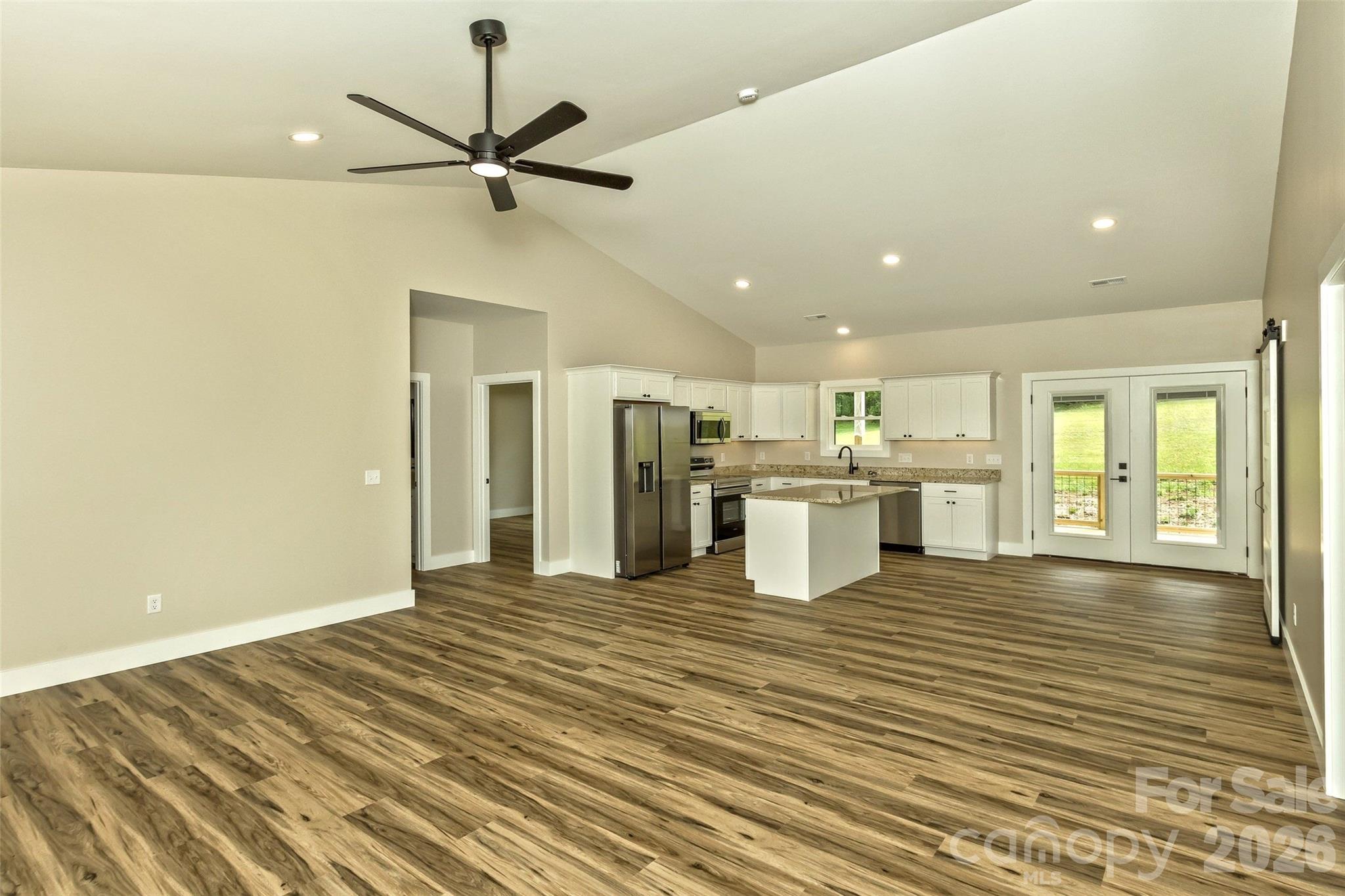 112 Peyton Elaine Road Clyde, NC 28721 - Photo 3 of 35 a view of a kitchen with wooden floor and a ceiling fan